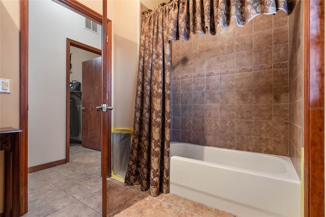 bathroom with shower / tub combo with curtain and tile patterned floors