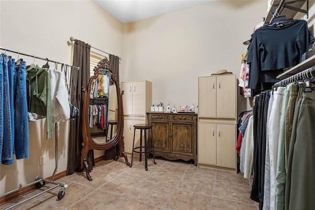 walk in closet with light tile patterned flooring