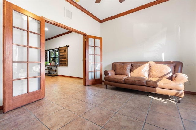 living room with ceiling fan, tile patterned flooring, and ornamental molding