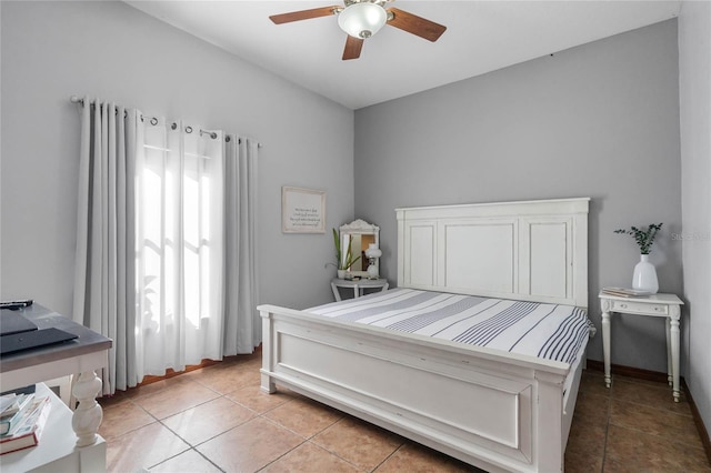 tiled bedroom featuring ceiling fan