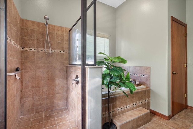 bathroom featuring tile patterned floors and a tile shower