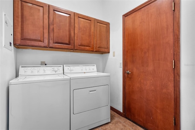 clothes washing area featuring light tile patterned floors, cabinets, and washing machine and clothes dryer