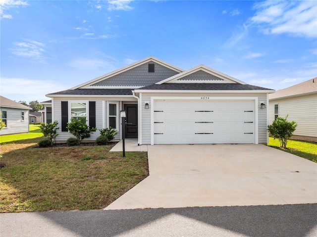 ranch-style house featuring a front lawn and a garage