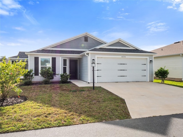 ranch-style home featuring a garage and a front yard