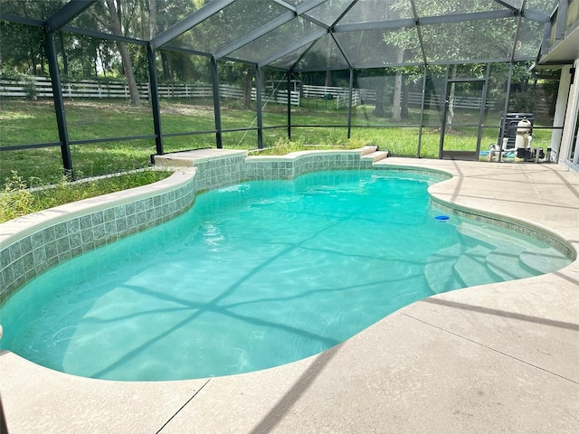 view of swimming pool featuring a lawn, a lanai, a patio, and pool water feature