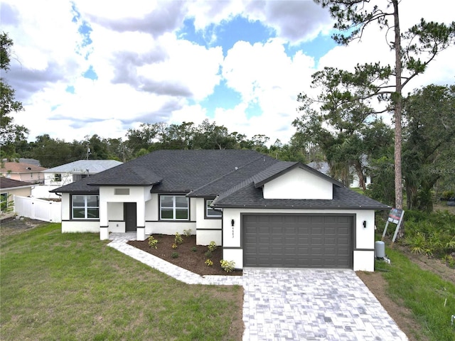 4683 Boston Ter, North Port, FL 34288 - view of front facade featuring stucco siding, roof with shingles, a garage, a front lawn, and driveway
