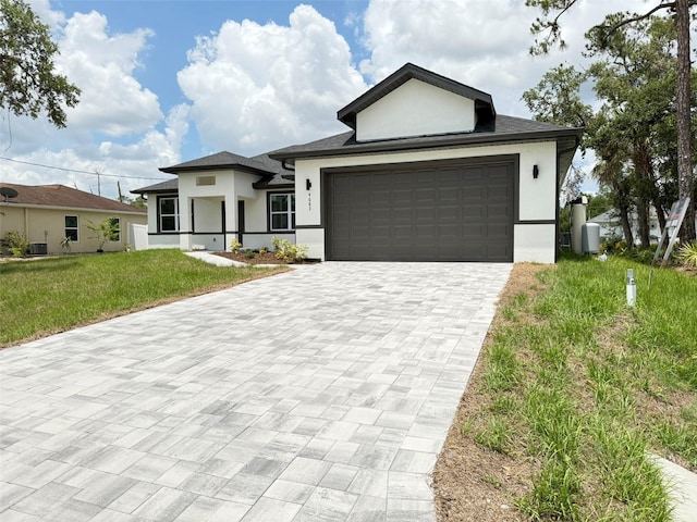 4683 Boston Ter, North Port, FL 34288 - ranch-style home featuring stucco siding, decorative driveway, a front lawn, and an attached garage