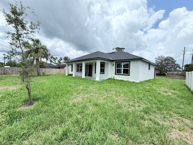 4683 Boston Ter, North Port, FL 34288 - rear view of property with stucco siding and a shingled roof