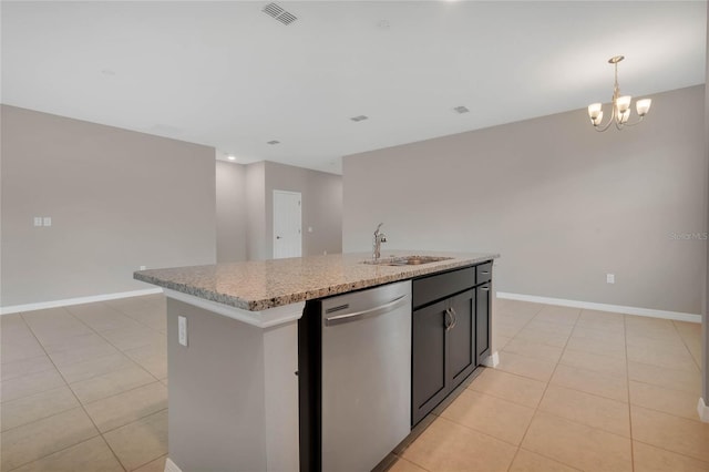 kitchen with light tile patterned flooring, sink, stainless steel dishwasher, a chandelier, and a kitchen island with sink