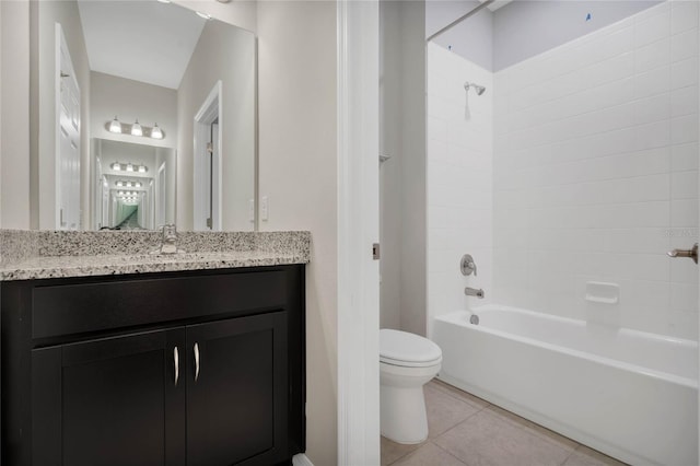 full bathroom featuring tiled shower / bath, tile patterned floors, toilet, and vanity