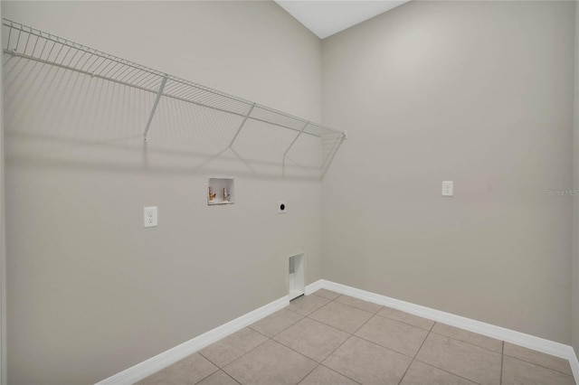 laundry area with washer hookup, electric dryer hookup, and light tile patterned floors