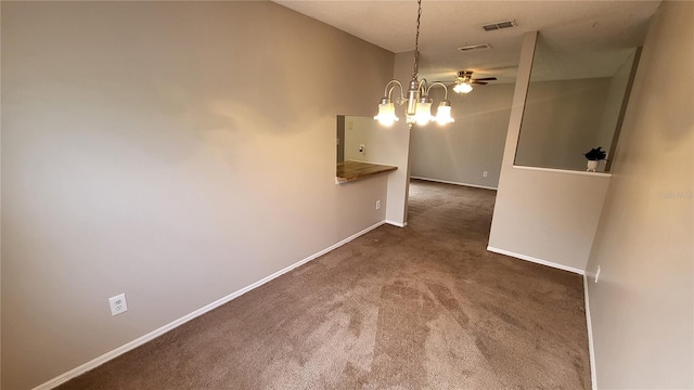 unfurnished room featuring dark carpet and ceiling fan with notable chandelier