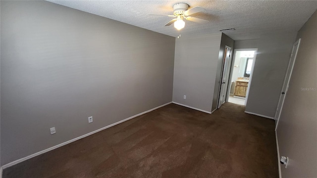 carpeted spare room with ceiling fan and a textured ceiling