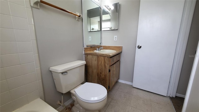 bathroom with tile patterned flooring, vanity, and toilet