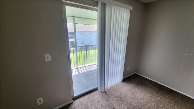 doorway to outside with a healthy amount of sunlight and carpet