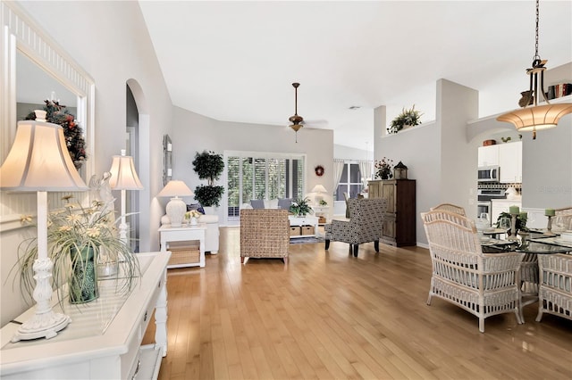 living room with ceiling fan and light wood-type flooring