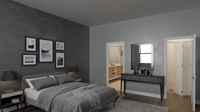 bedroom with light hardwood / wood-style floors and ensuite bathroom