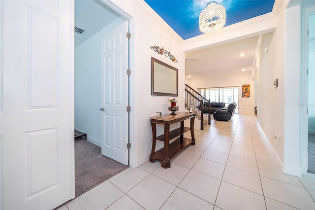 corridor featuring light carpet and crown molding