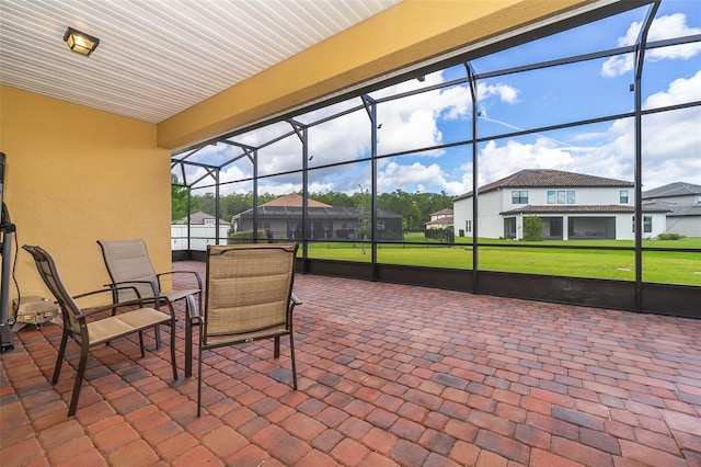 view of patio featuring a lanai