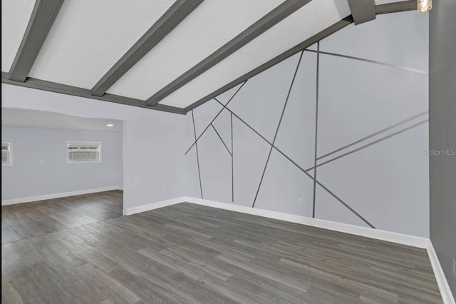 interior space featuring vaulted ceiling with beams and dark hardwood / wood-style floors