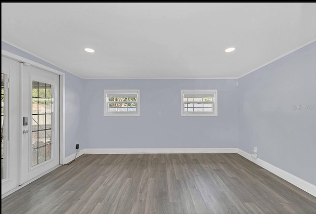 unfurnished room with hardwood / wood-style floors and ornamental molding