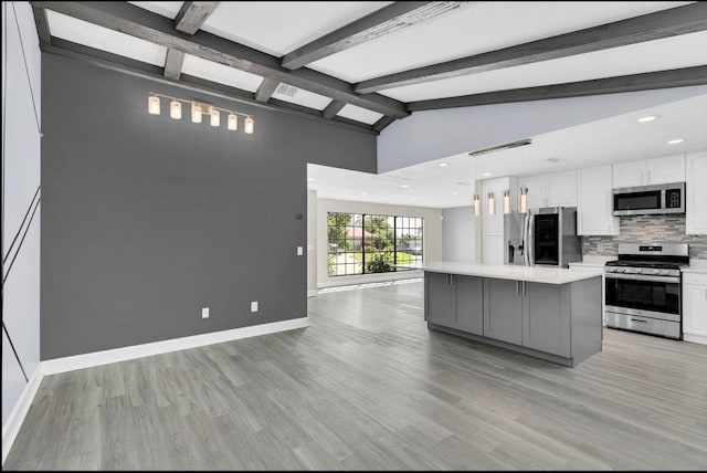 kitchen featuring a center island, light wood-type flooring, white cabinetry, and appliances with stainless steel finishes