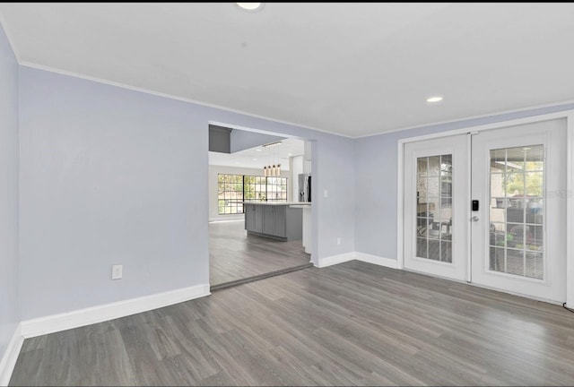 empty room featuring hardwood / wood-style floors, french doors, and a wealth of natural light