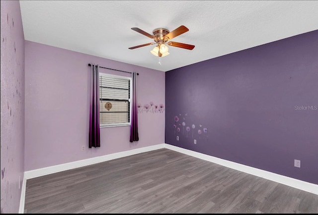 unfurnished room featuring a textured ceiling, dark hardwood / wood-style floors, and ceiling fan