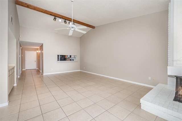 unfurnished living room with light tile patterned flooring, ceiling fan, a textured ceiling, and vaulted ceiling with beams