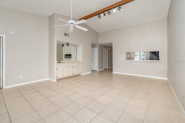 unfurnished living room featuring beamed ceiling, sink, ceiling fan, light tile patterned floors, and high vaulted ceiling