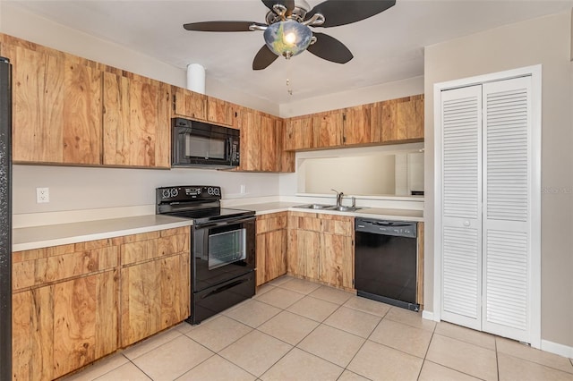 kitchen featuring black appliances, sink, light tile patterned floors, and ceiling fan