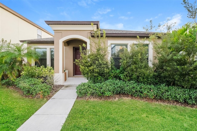 entrance to property with a lawn