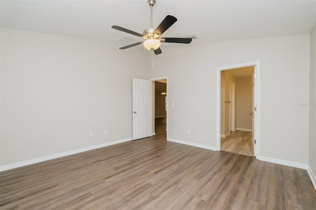 spare room featuring hardwood / wood-style flooring, ceiling fan, and lofted ceiling