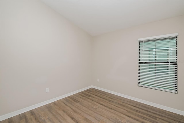 unfurnished room with wood-type flooring