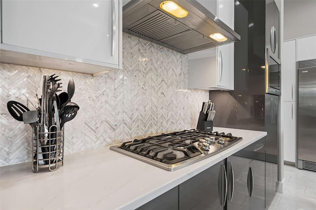 kitchen featuring white cabinetry, appliances with stainless steel finishes, and premium range hood