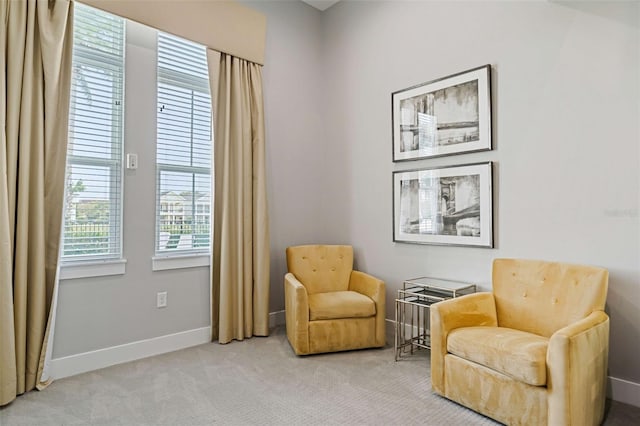 sitting room featuring light colored carpet