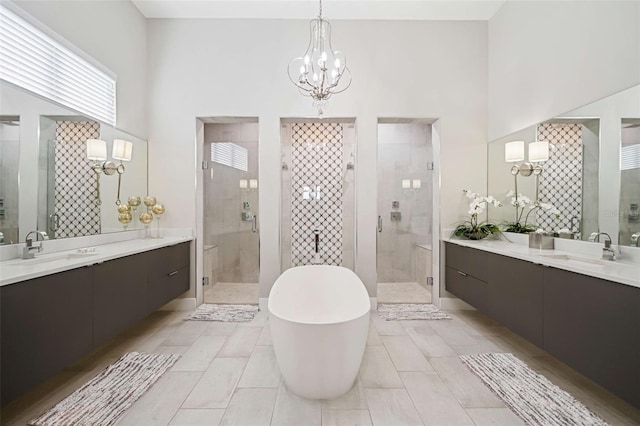 bathroom featuring separate shower and tub, a chandelier, tile patterned floors, and a high ceiling