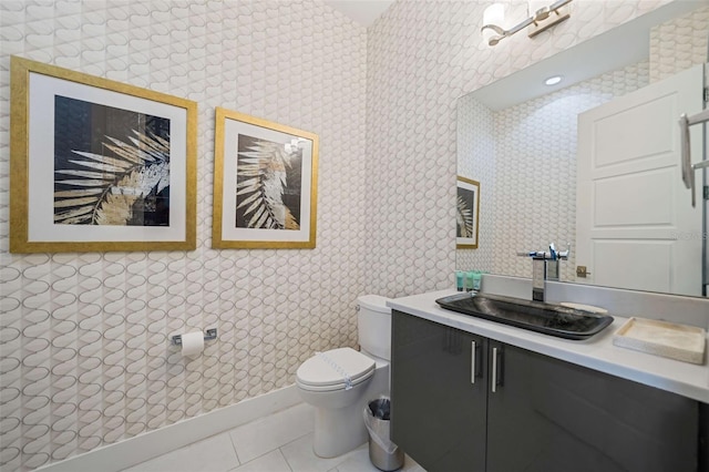 bathroom with tile patterned flooring, vanity, and toilet