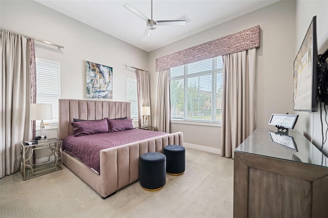 carpeted bedroom featuring multiple windows and ceiling fan