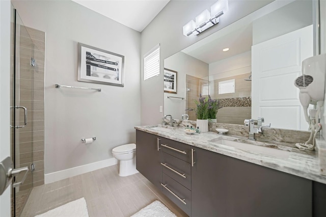 bathroom with tile patterned flooring, vanity, toilet, and an enclosed shower