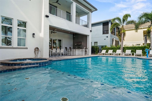 view of swimming pool with ceiling fan, an in ground hot tub, and a patio area