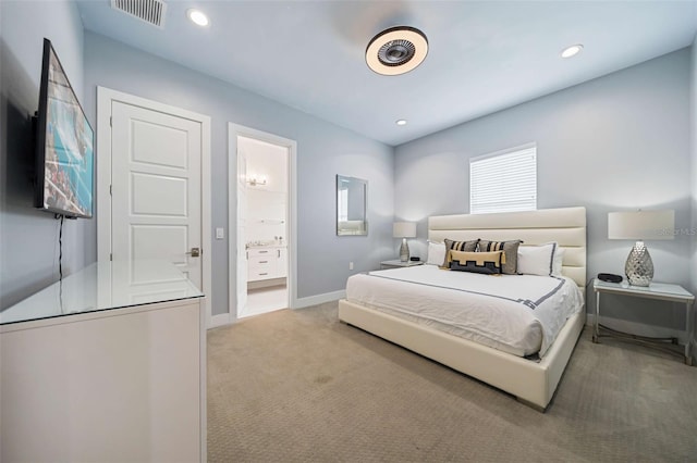 carpeted bedroom featuring ensuite bathroom