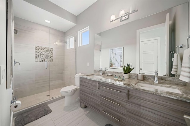 bathroom with a shower with door, vanity, toilet, and tile patterned flooring