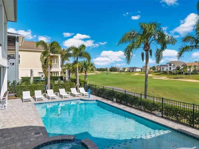 view of swimming pool with a yard, a patio, and an in ground hot tub