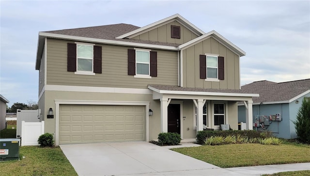 craftsman house with covered porch, a garage, and a front yard