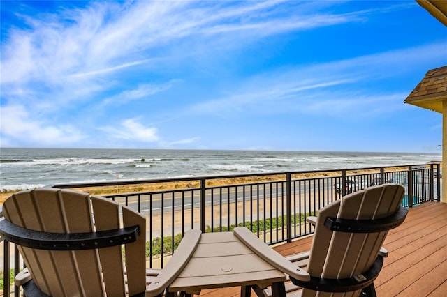 balcony with a water view and a beach view