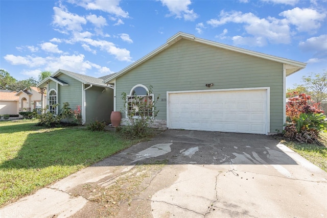 view of front of house featuring a garage and a front lawn