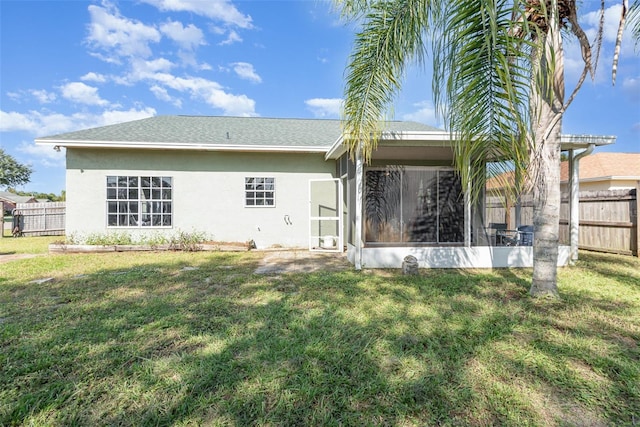 rear view of property featuring a yard