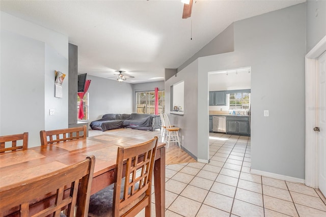 tiled dining space with ceiling fan and sink