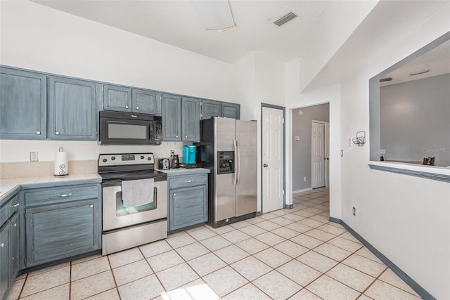 kitchen featuring light tile patterned flooring and stainless steel appliances